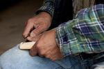 Nisga’a Carver Hammy Martin repairing a tool, British Columbia, Canada, 2010